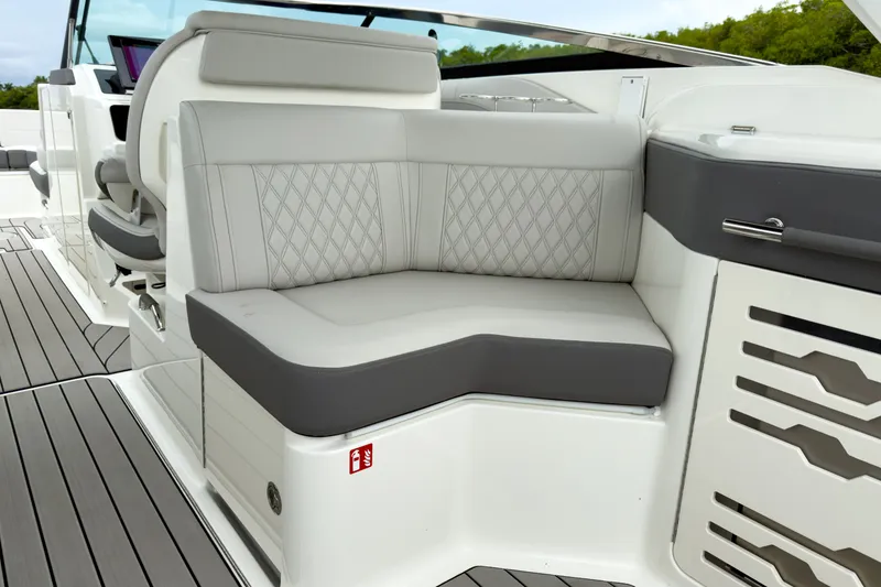 Slide: The Image of The 2027 Sea Ray SLX 310 Outboard features an elegant, cushioned seating area with gray accents. - 11