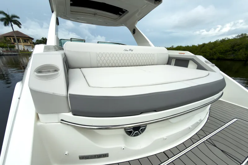 Slide: The Image of The 2027 Sea Ray SLX 310 Outboard features a luxurious, cushioned sunpad at the stern. - 6