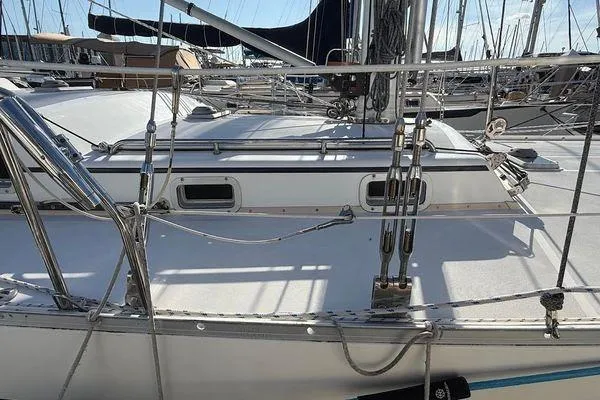 Slide: The Image of Sailboat deck of 2011 Reliance 44, featuring rigging and marina background. - 13