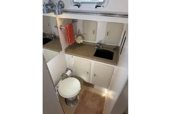 Slide: The Image of Compact bathroom in 2011 Reliance 44 yacht with sink, toilet, and storage cabinets. - 22
