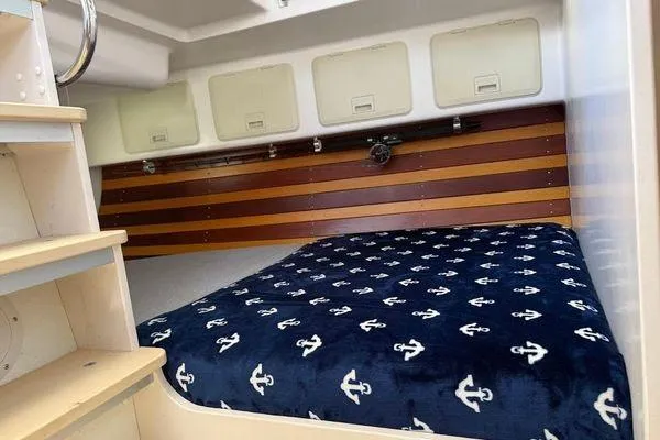 Slide: The Image of Cozy cabin interior of 2011 Reliance 44 with anchor-patterned bedding. - 27