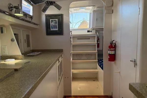 Slide: The Image of Interior of 2011 Reliance 44 yacht with modern kitchen and staircase. - 29