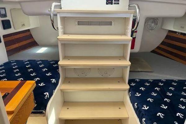 Slide: The Image of Interior of 2011 Reliance 44 yacht with wooden steps and nautical-themed bedding. - 37