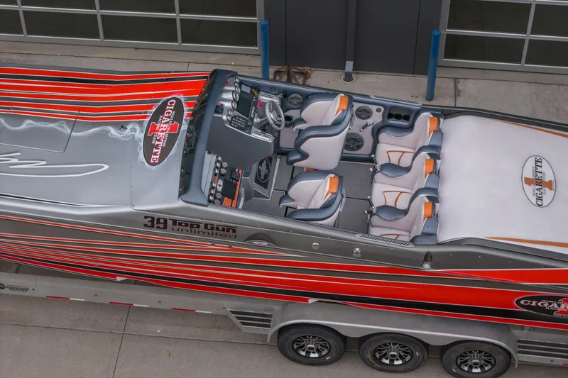 Slide: The Image of 2006 Cigarette 39' Top Gun Unlimited boat with sleek design and vibrant red stripes. - 10