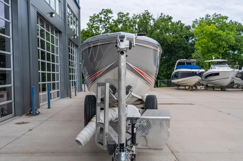 Slide: The Image of 2006 Cigarette 39' Top Gun Unlimited boat on trailer near modern building. - 12