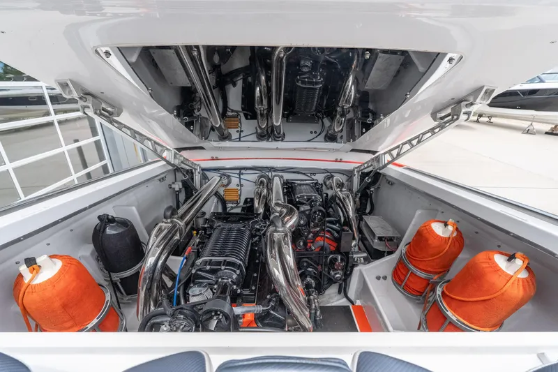 Slide: The Image of Engine compartment of a 2006 Cigarette 39' Top Gun Unlimited boat, showcasing powerful machinery. - 18