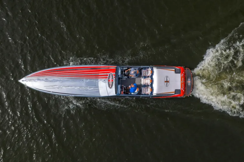 Slide: The Image of 2006 Cigarette 39' Top Gun speedboat cruising on water, aerial view. - 2