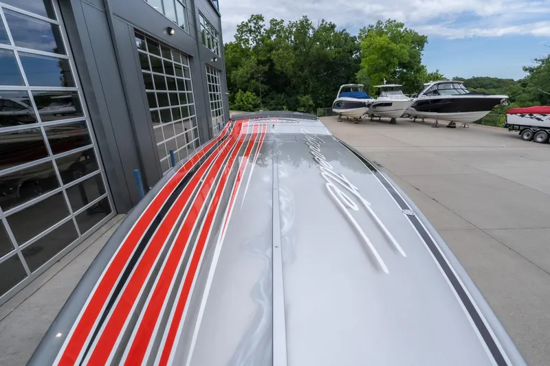 Slide: The Image of 2006 Cigarette 39' Top Gun Unlimited boat with sleek red and black stripes. - 26