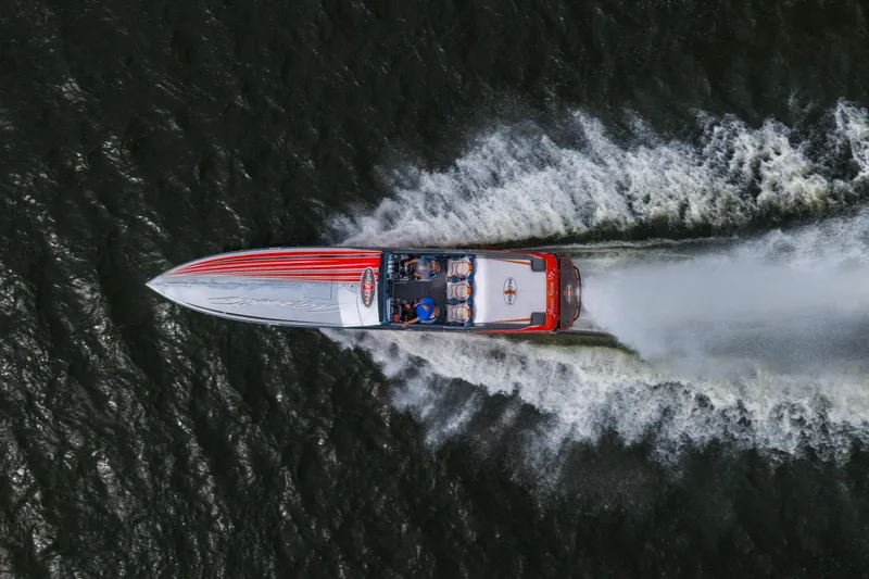 Slide: The Image of Aerial view of a 2006 Cigarette 39' Top Gun speedboat racing on water. - 3