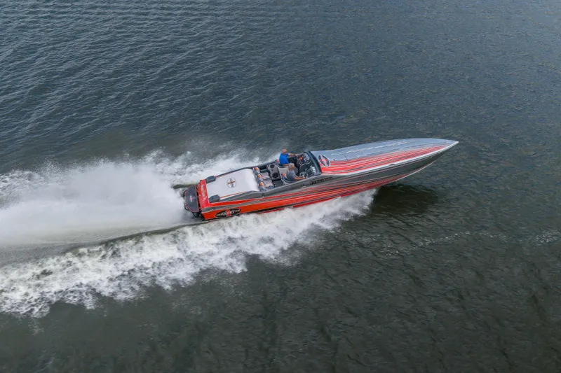 Slide: The Image of 2006 Cigarette 39' Top Gun speedboat cruising on open water, showcasing sleek design and performance. - 4