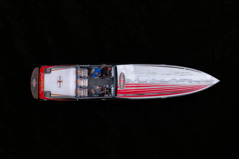 Slide: The Image of Overhead view of a 2006 Cigarette 39' Top Gun speedboat with red and white design. - 7