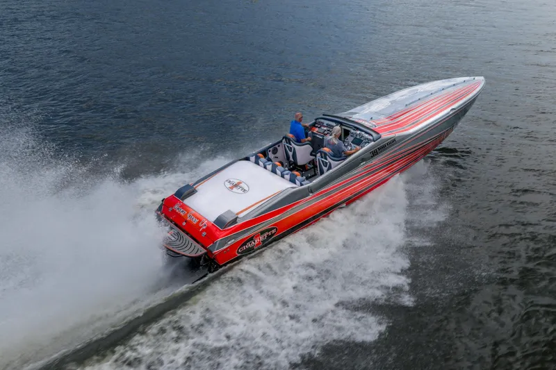 Slide: The Image of 2006 Cigarette 39' Top Gun speedboat cruising on water, featuring vibrant red and silver design. - 8