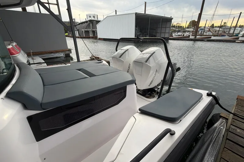 Slide: The Image of 2022 Axopar Brabus 37 XC Cross Cabin with twin Mercury engines docked at marina. - 10