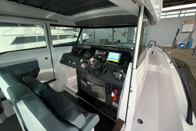 Slide: The Image of Interior of 2022 Axopar Brabus 37 XC Cross Cabin, featuring modern dashboard and seating. - 13