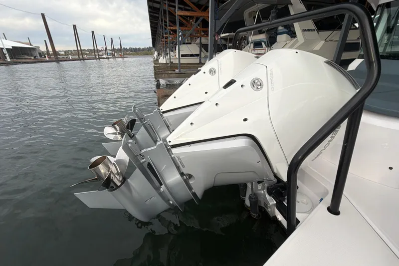 Slide: The Image of Twin outboard engines on a 2022 Axopar Brabus 37 XC Cross Cabin at a marina. - 14