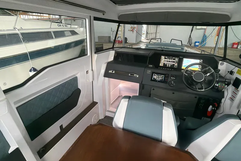 Slide: The Image of Interior of 2022 Axopar Brabus 37 XC Cross Cabin with modern dashboard and seating. - 18
