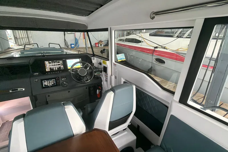 Slide: The Image of Interior of 2022 Axopar Brabus 37 XC Cross Cabin with modern dashboard and seating. - 19