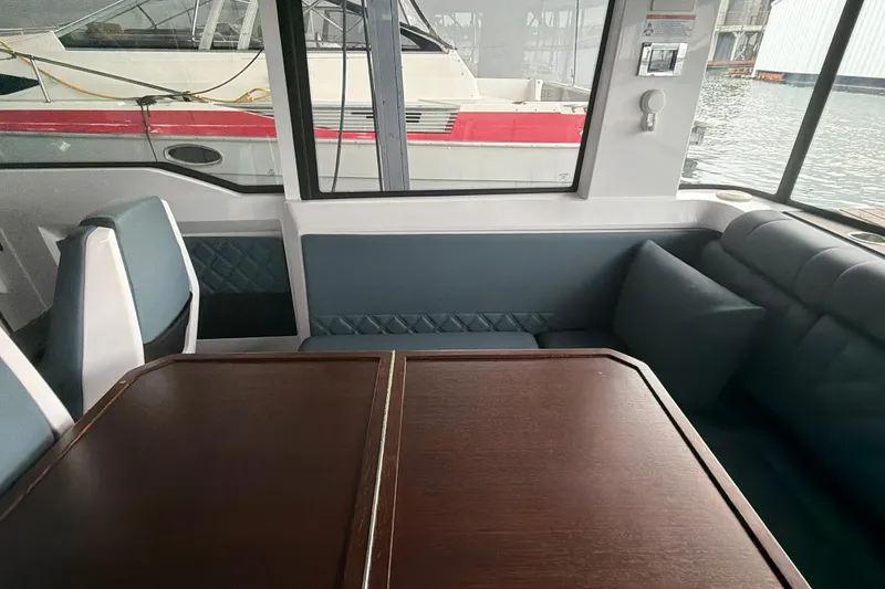 Slide: The Image of Interior of 2022 Axopar Brabus 37 XC Cross Cabin with elegant seating and table. - 21