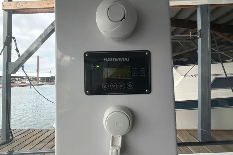 Slide: The Image of Control panel on 2022 Axopar Brabus 37 XC Cross Cabin boat docked by the water. - 22