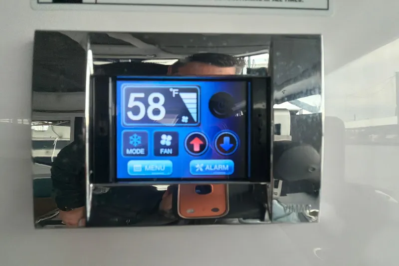 Slide: The Image of Digital control panel on 2022 Axopar Brabus 37 XC Cross Cabin displaying 58°F. - 23