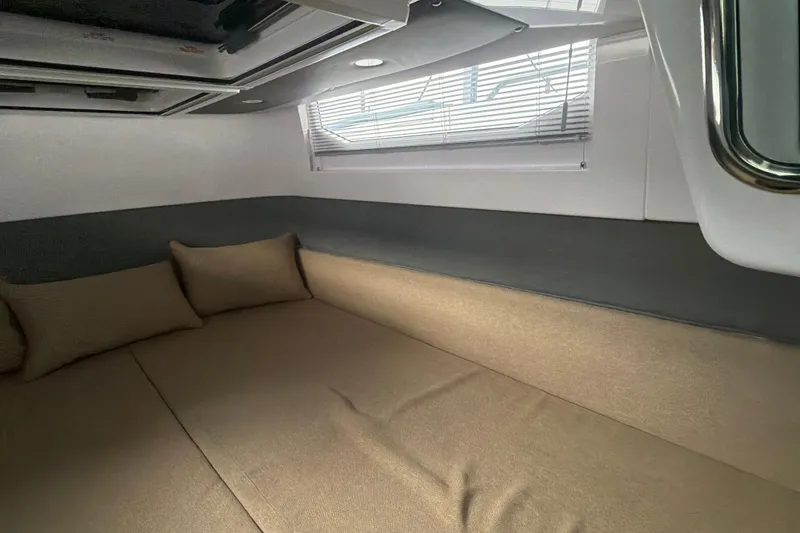 Slide: The Image of Interior cabin of 2022 Axopar Brabus 37 XC Cross Cabin with beige cushions. - 25