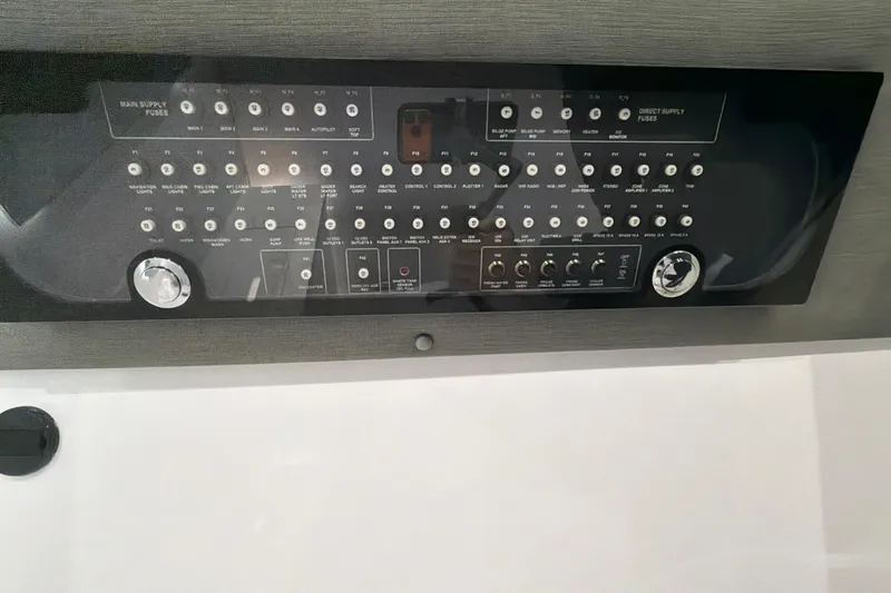 Slide: The Image of Control panel of 2022 Axopar Brabus 37 XC Cross Cabin boat, featuring various switches and dials. - 31