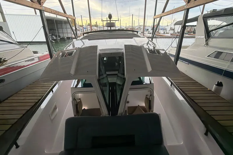 Slide: The Image of 2022 Axopar Brabus 37 XC Cross Cabin docked in a marina, showcasing sleek design. - 35