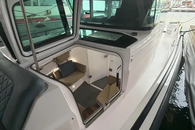 Slide: The Image of 2022 Axopar Brabus 37 XC Cross Cabin interior view with seating area. - 36