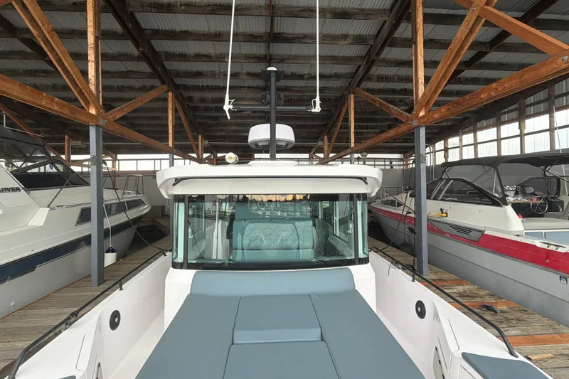 Slide: The Image of 2022 Axopar Brabus 37 XC Cross Cabin docked in a covered marina. - 38
