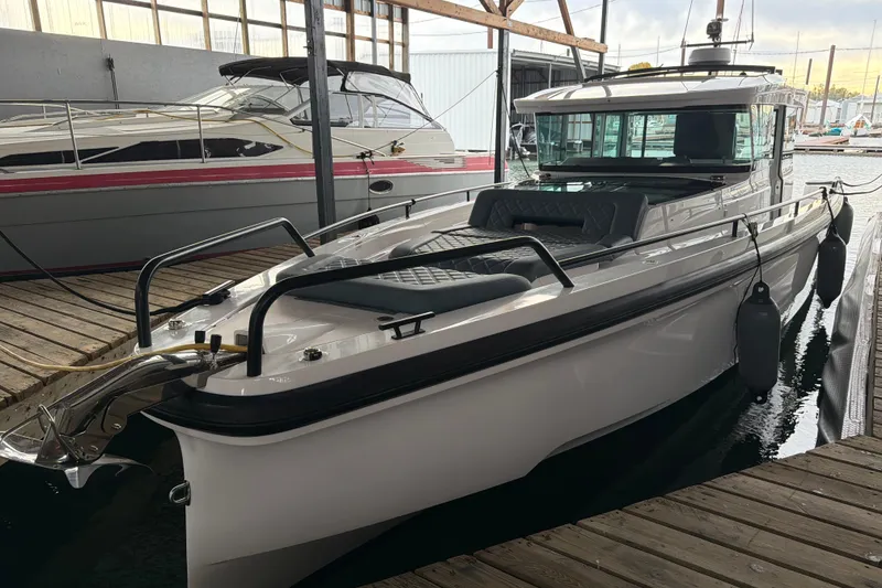 Slide: The Image of 2022 Axopar Brabus 37 XC Cross Cabin docked in a marina. - 7
