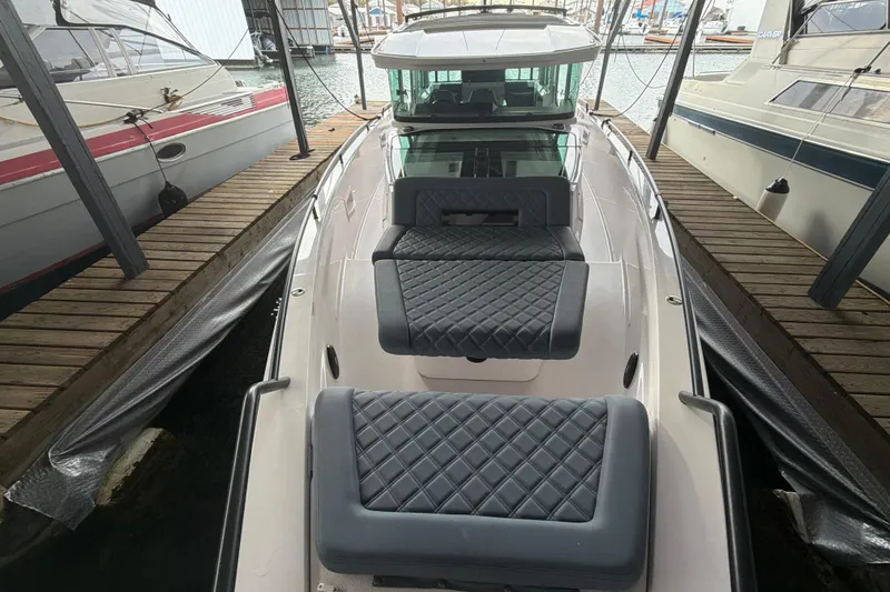 Slide: The Image of 2022 Axopar Brabus 37 XC Cross Cabin docked, featuring luxurious quilted seating. - 8