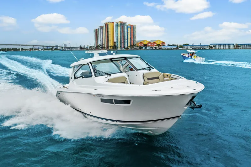 Slide: The Image of Pursuit DC 365 Dual Console 2021 on blue water with cityscape backdrop. - 14