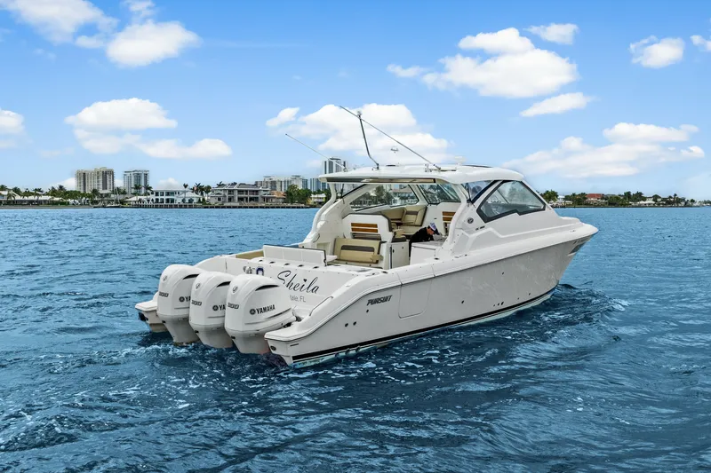 Slide: The Image of 2021 Pursuit DC 365 Dual Console on the water. - 2