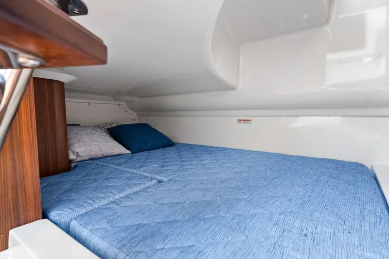 Slide: The Image of Interior of 2021 Pursuit DC 365 Dual Console with blue bedding. - 30