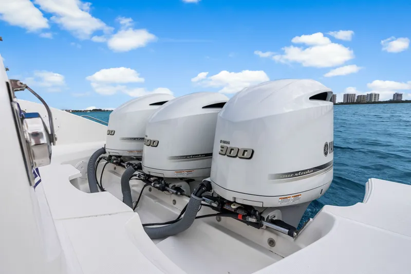 Slide: The Image of Pursuit DC 365 boat with three Yamaha 300 engines on the water. - 36