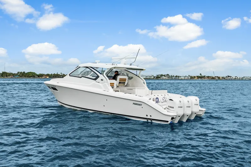 Slide: The Image of 2021 Pursuit DC 365 Dual Console on the water. - 7