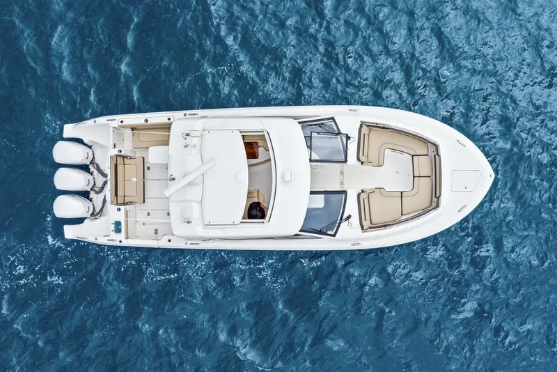 Slide: The Image of Aerial view of Pursuit DC 365 Dual Console boat on water. - 8