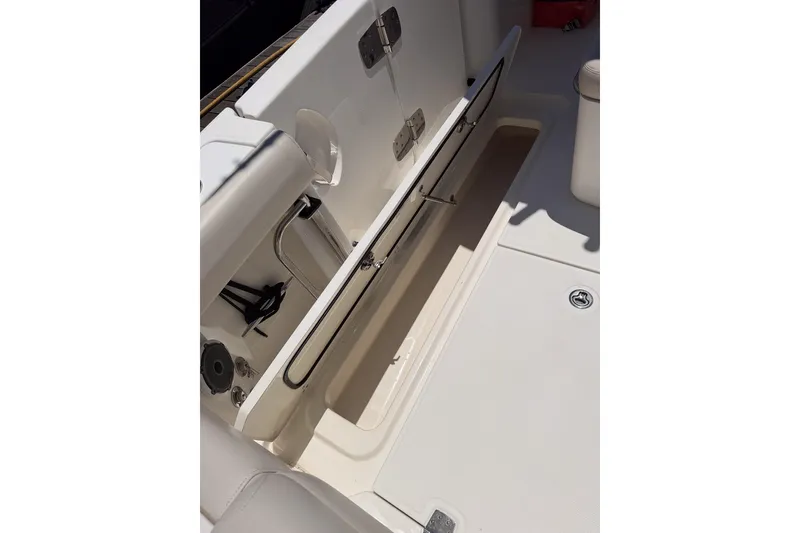 Slide: The Image of 2021 Boston Whaler 330 Outrage boat storage compartment with open hatch. - 15