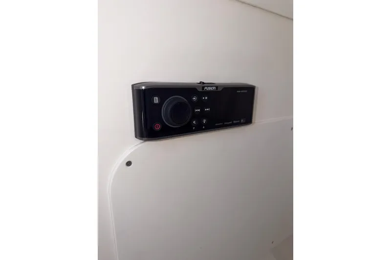 Slide: The Image of Fusion marine stereo system on 2021 Boston Whaler 330 Outrage boat interior. - 25