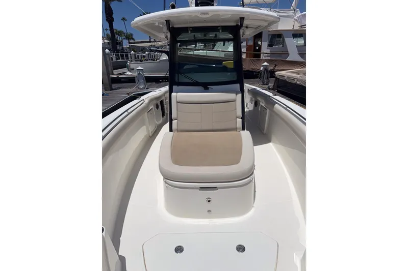 Slide: The Image of 2021 Boston Whaler 330 Outrage boat interior with cushioned seating and sleek design. - 29