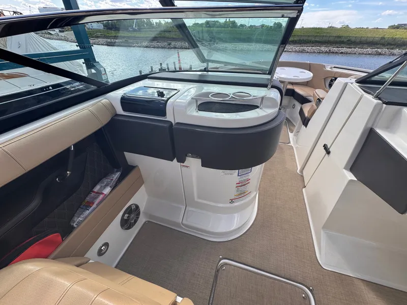 Slide: The Image of Interior of a 2019 Sea Ray SLX 280 yacht by the water. - 16