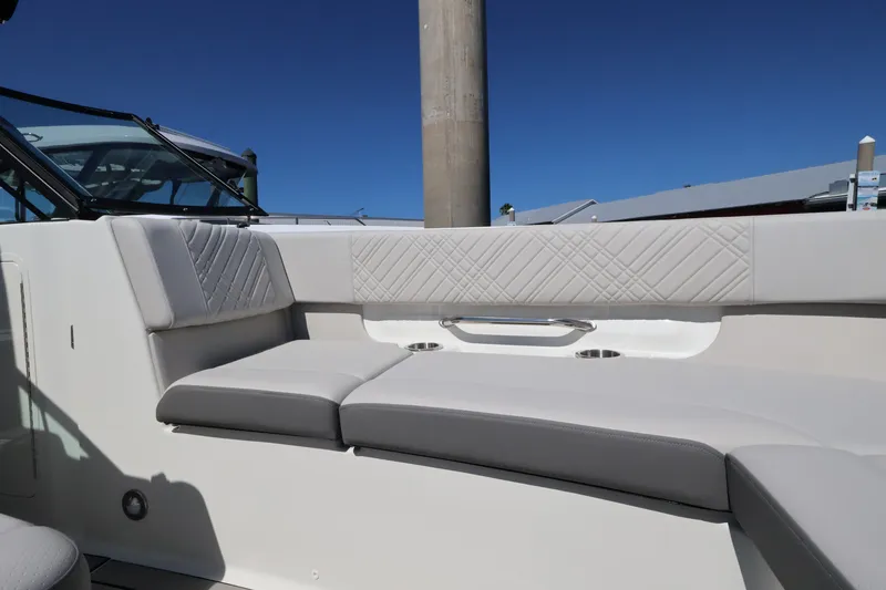Slide: The Image of The 2027 Sea Ray SDX 270 Outboard features a sleek, cushioned seating area with modern stitching. - 35