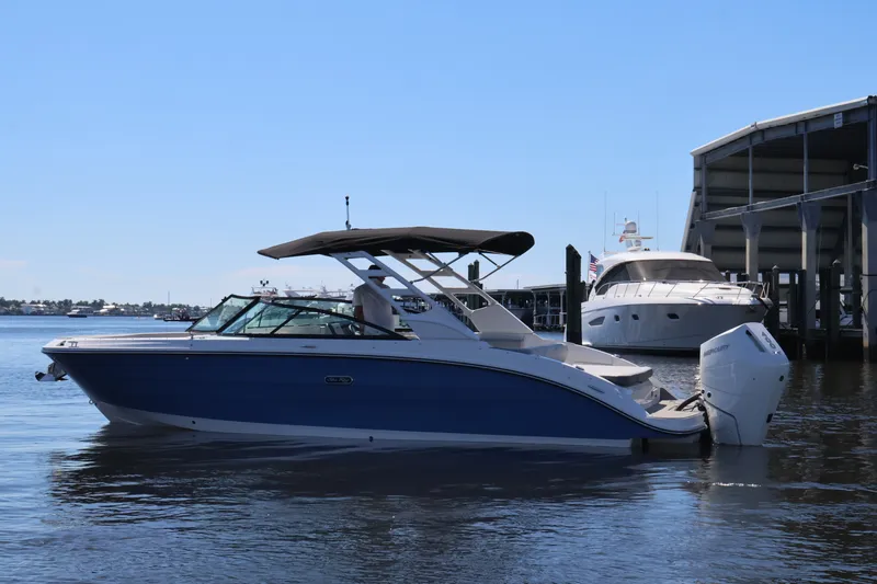 Slide: The Image of 2027 Sea Ray SDX 270 Outboard on water, featuring a blue hull and white outboard motor. - 9