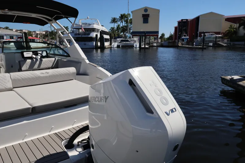 Slide: The Image of The image shows a Sea Ray SDX 270 Outboard boat at a marina with a Mercury 400 engine. - 12