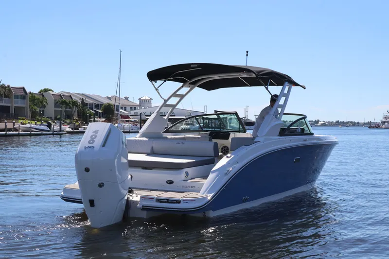 Slide: The Image of A 2027 Sea Ray SDX 270 Outboard on the water, featuring a blue hull and black sunshade. - 4