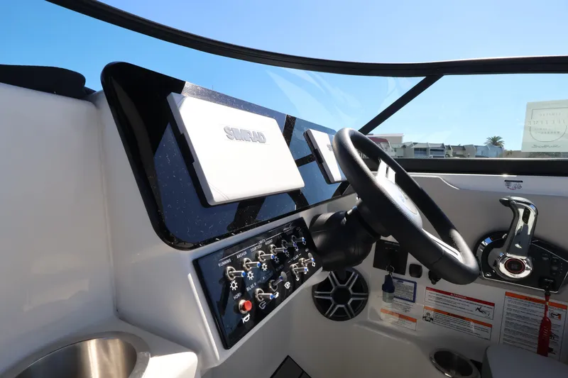 Slide: The Image of The Sea Ray SDX 270 Outboard cockpit features a modern helm with a large display. - 25