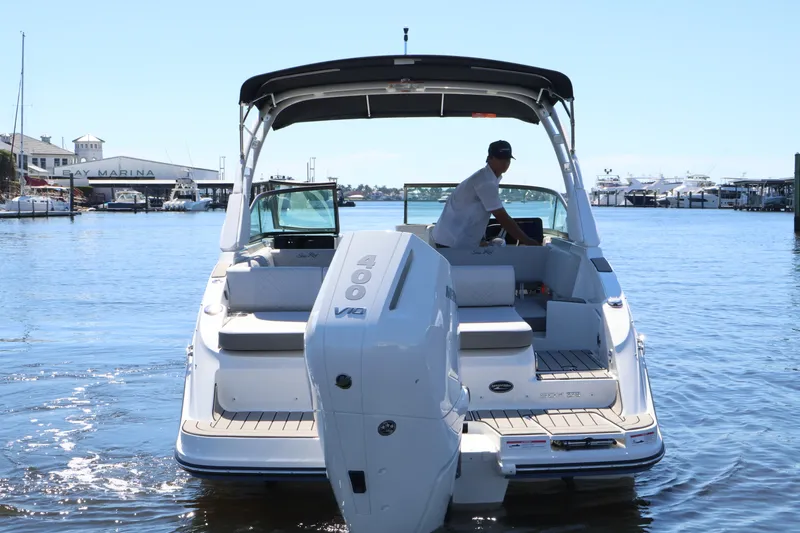 Slide: The Image of A 2027 Sea Ray SDX 270 Outboard on the water, with a man at the helm. - 5