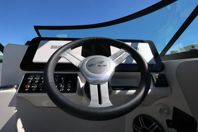 Slide: The Image of The image shows the helm of a Sea Ray SDX 270 Outboard boat with modern instruments. - 24