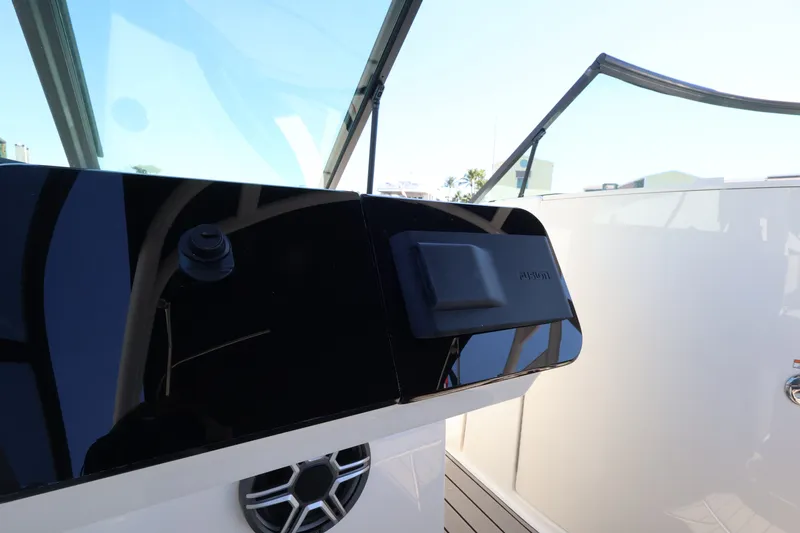Slide: The Image of The image shows the cockpit of a 2027 Sea Ray SDX 270 Outboard with modern controls. - 26