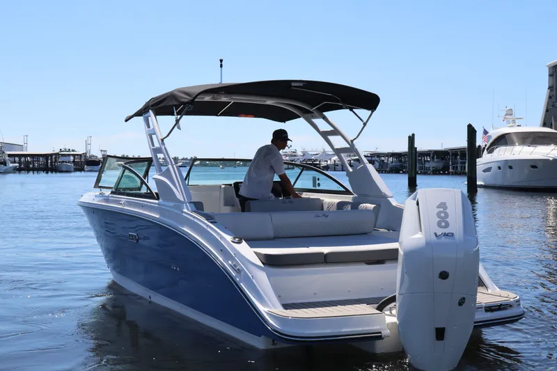 Slide: The Image of A 2027 Sea Ray SDX 270 Outboard on the water, featuring a black canopy and white outboard engine. - 6